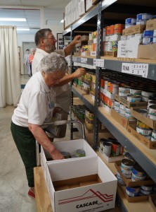 Two Volunteers sort food for Newberg FISH