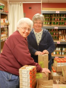 Two Newberg FISH Volunteers sorting food